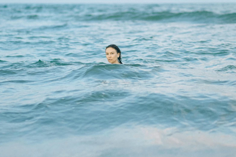 a woman that is in the water with a surfboard, by Emma Andijewska, unsplash, renaissance, dafne keen, marina abramovic, swimming in ocean, rinko kawauchi