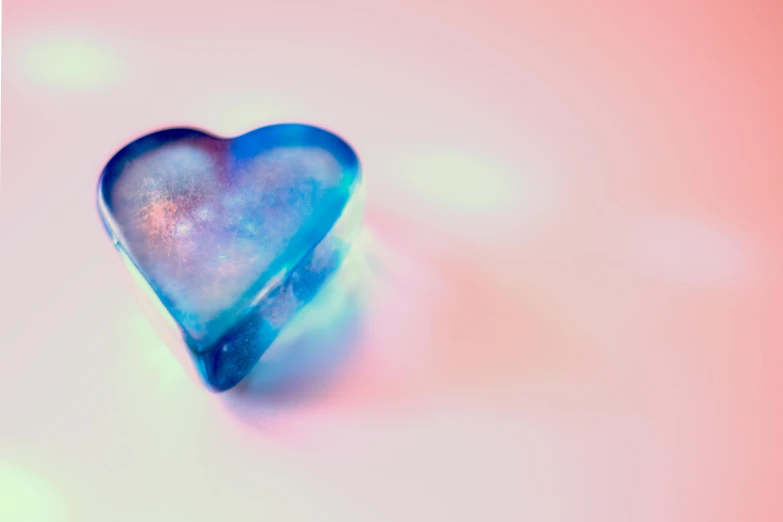 a heart shaped object sitting on top of a table, inspired by Tracey Emin, trending on pexels, gradient sapphire, ice queen, lgbtq, beautiful”