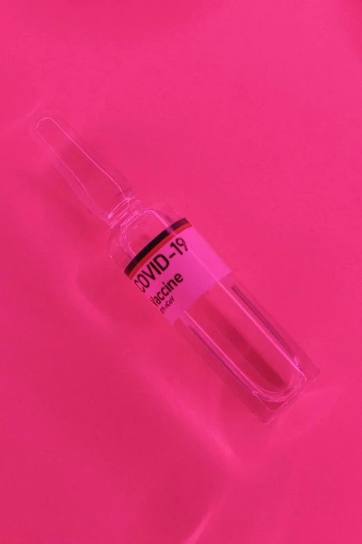 a bottle of liquid sitting on top of a pink surface, holding syringe, thumbnail, ((pink)), covid