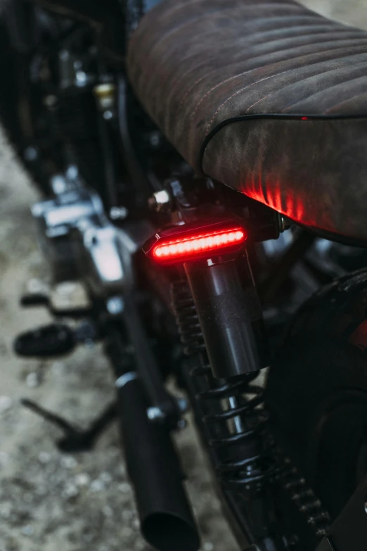 a close up of a motorcycle with a red light, a pair of ribbed, full product shot, jinx, titanium