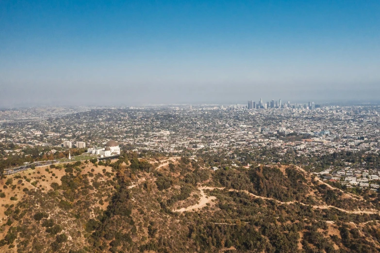 a view of a city from the top of a hill, hollywood promotional image, view from helicopter, landscape photo, jen atkin