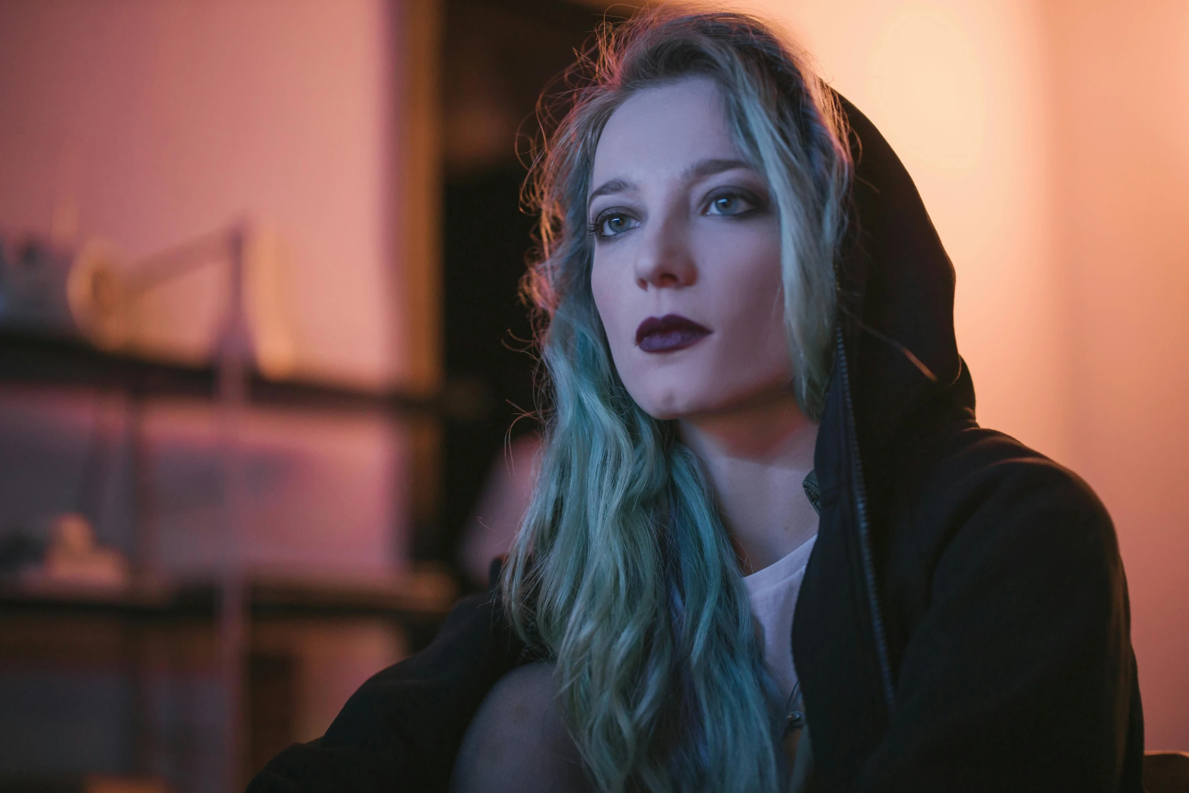 a woman with blue hair wearing a black hoodie, a portrait, inspired by Elsa Bleda, trending on pexels, with long blond hair, pokimane, low lights, attractive androgynous humanoid