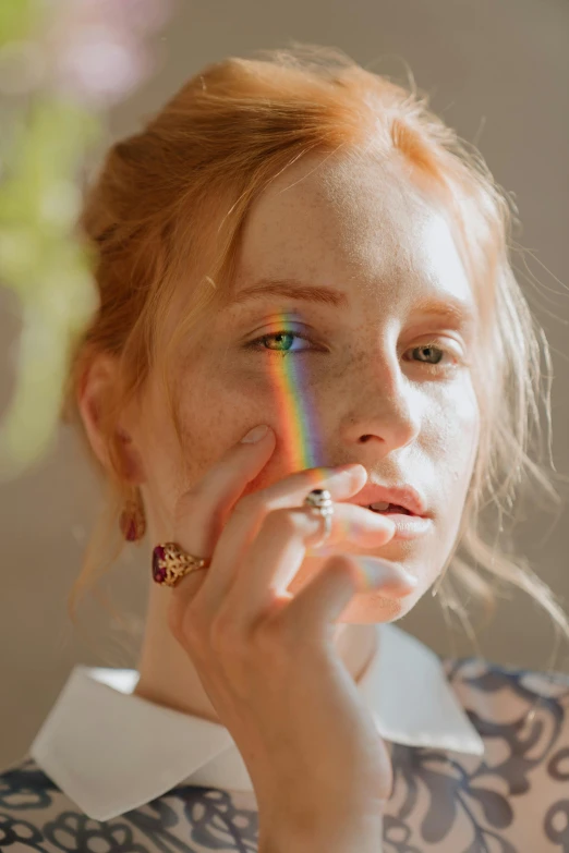 a woman holding a cigarette in front of her face, trending on pexels, renaissance, ethereal rainbows, ginger hair, rainbow accents, light haze