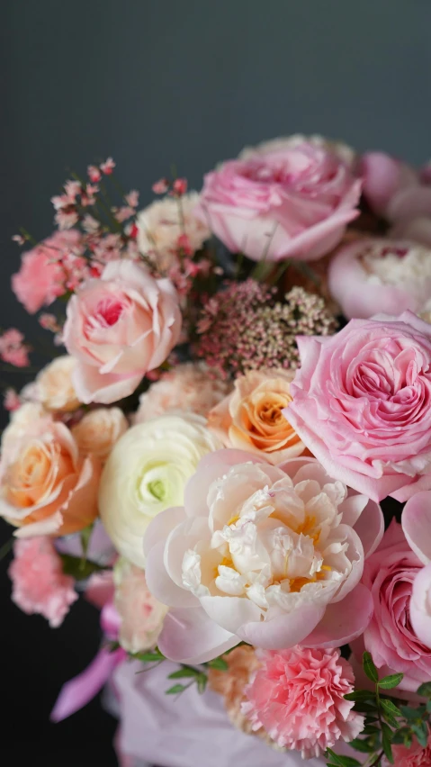 a bouquet of flowers sitting on top of a table, on grey background, pink and pink details, zoomed in, in detail