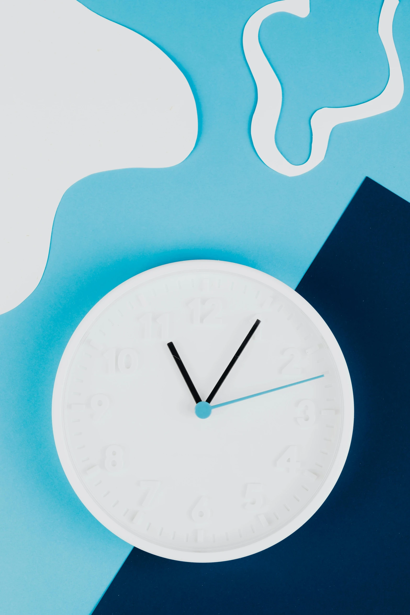 a clock sitting on top of a blue and white surface, hypermodernism, thumbnail, sleek white, paper cutouts of plain colors, detailed product shot