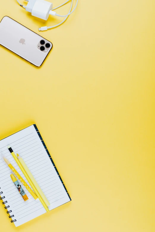 a laptop, headphones and a notebook on a yellow background, trending on pexels, pencils, iphone wallpaper, no - text no - logo, from waist up