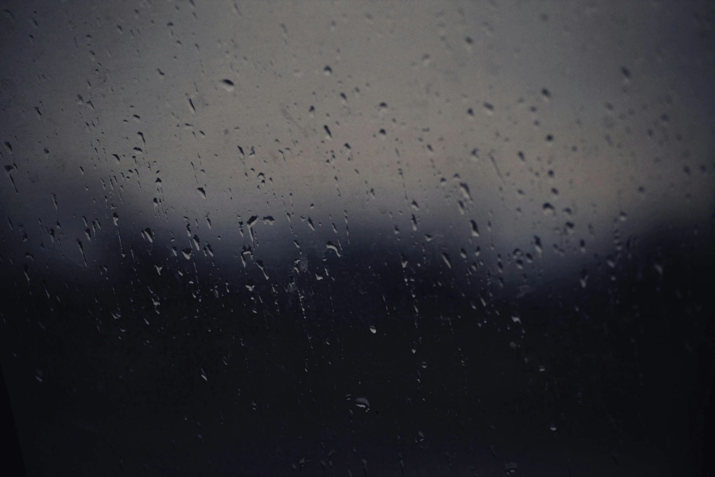 a close up of a window with raindrops on it, pexels, realism, background image, gloomy landscape, chilly dark mood, monsoon