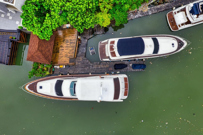 a couple of boats sitting on top of a body of water, pexels contest winner, birds eye overhead perspective, bangkok, bored ape yacht club, slide show