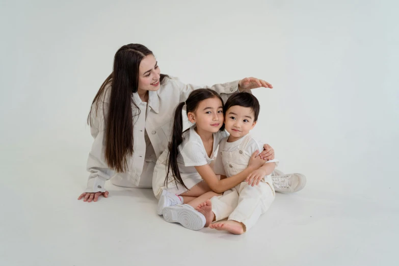 a woman and two children sitting on the floor, a picture, pexels contest winner, wearing off - white style, with a white background, gongbi, high quality image