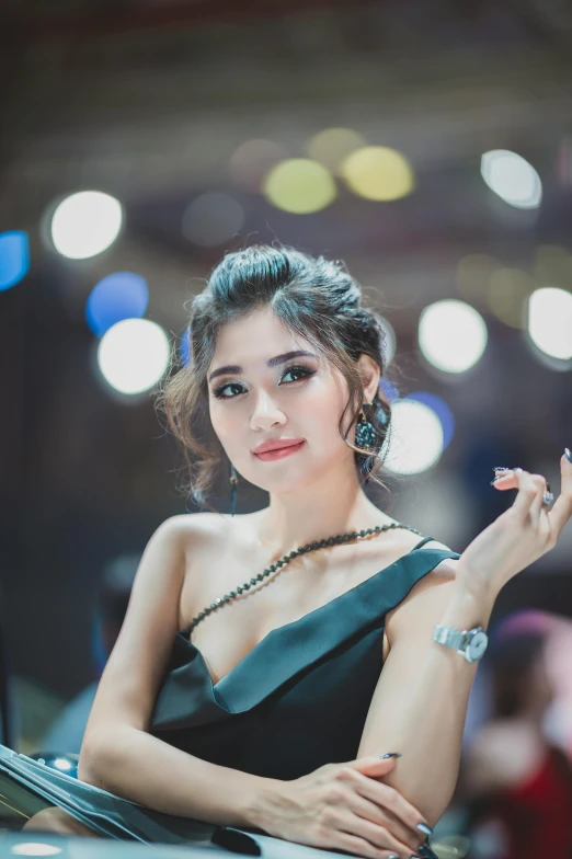 a woman in a green dress sitting on top of a car, by Natasha Tan, trending on pexels, natalia dyer, south east asian with round face, half-turned lady in evening gown, 8k artgerm bokeh