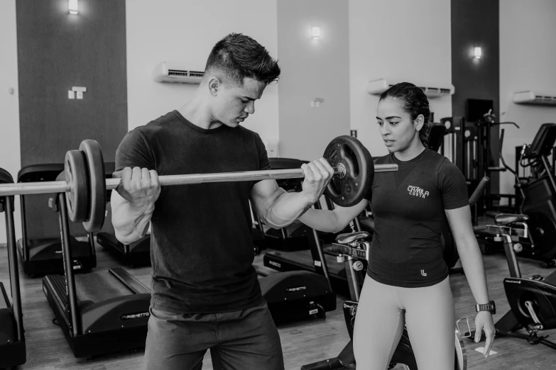 a man and a woman working out in a gym, a black and white photo, 🦑 design, nivanh chanthara, background image, young man with short