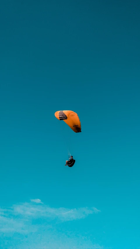 a person that is flying a kite in the sky, pexels contest winner, minimalism, blue!! with orange details, avatar image, buggy, parachutes