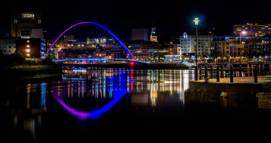 a bridge over a body of water at night, by Steve Prescott, pexels contest winner, graffiti, neon city domes, yorkshire, panoramic, fan favorite