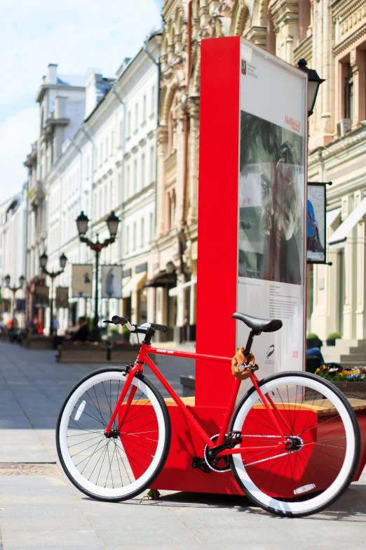 a red bike parked on the side of a street, a poster, by karlkka, kremlin, art stand, eero aarnio, white red