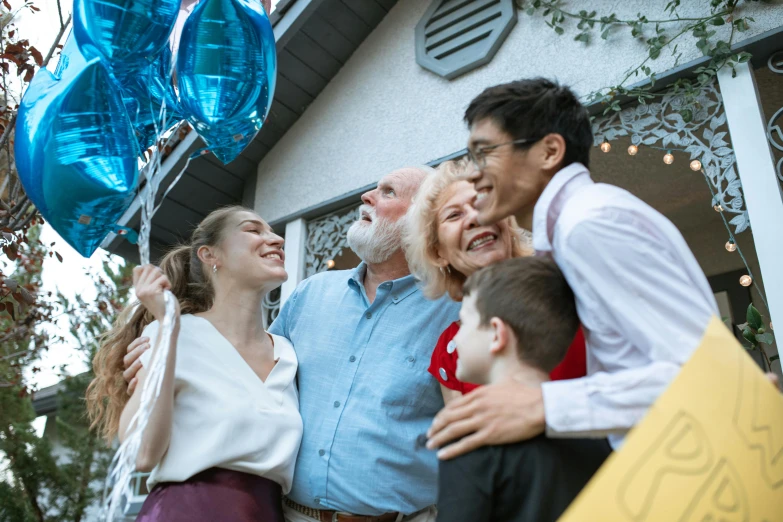 a group of people standing in front of a house, pexels contest winner, happening, party balloons, an oldman, profile image, happy kid