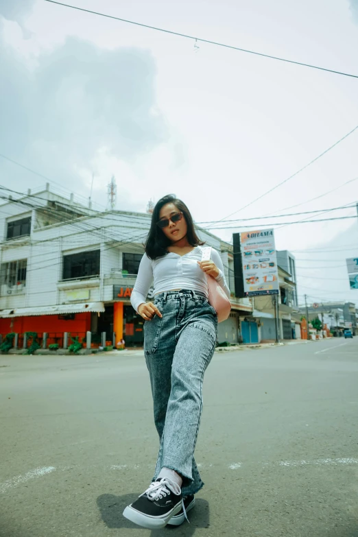 a woman standing on a skateboard on a city street, by Basuki Abdullah, trending on pexels, photorealism, wearing pants, with sunglass, standing in a township street, portrait of modern darna