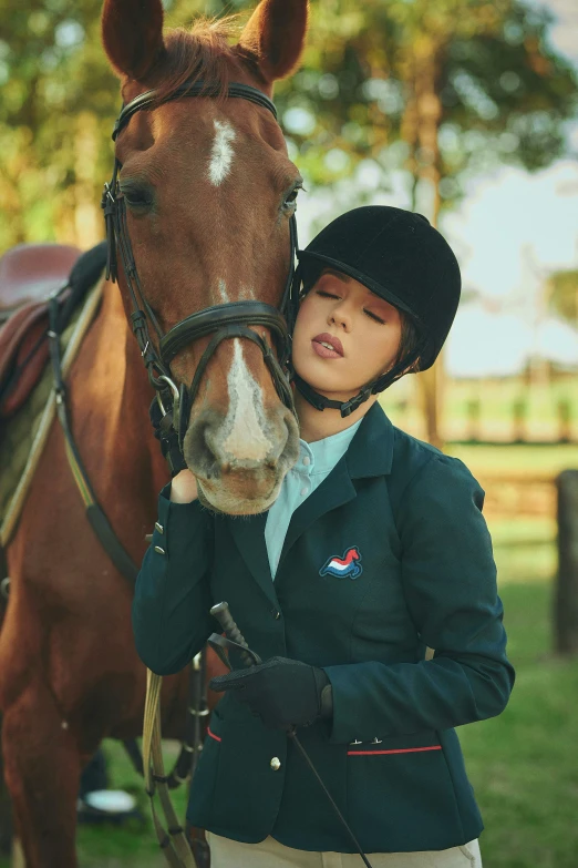 a woman standing next to a brown horse, a portrait, inspired by George Lambourn, trending on pexels, wearing a tracksuit, girl wearing uniform, wearing blue jacket, pouting