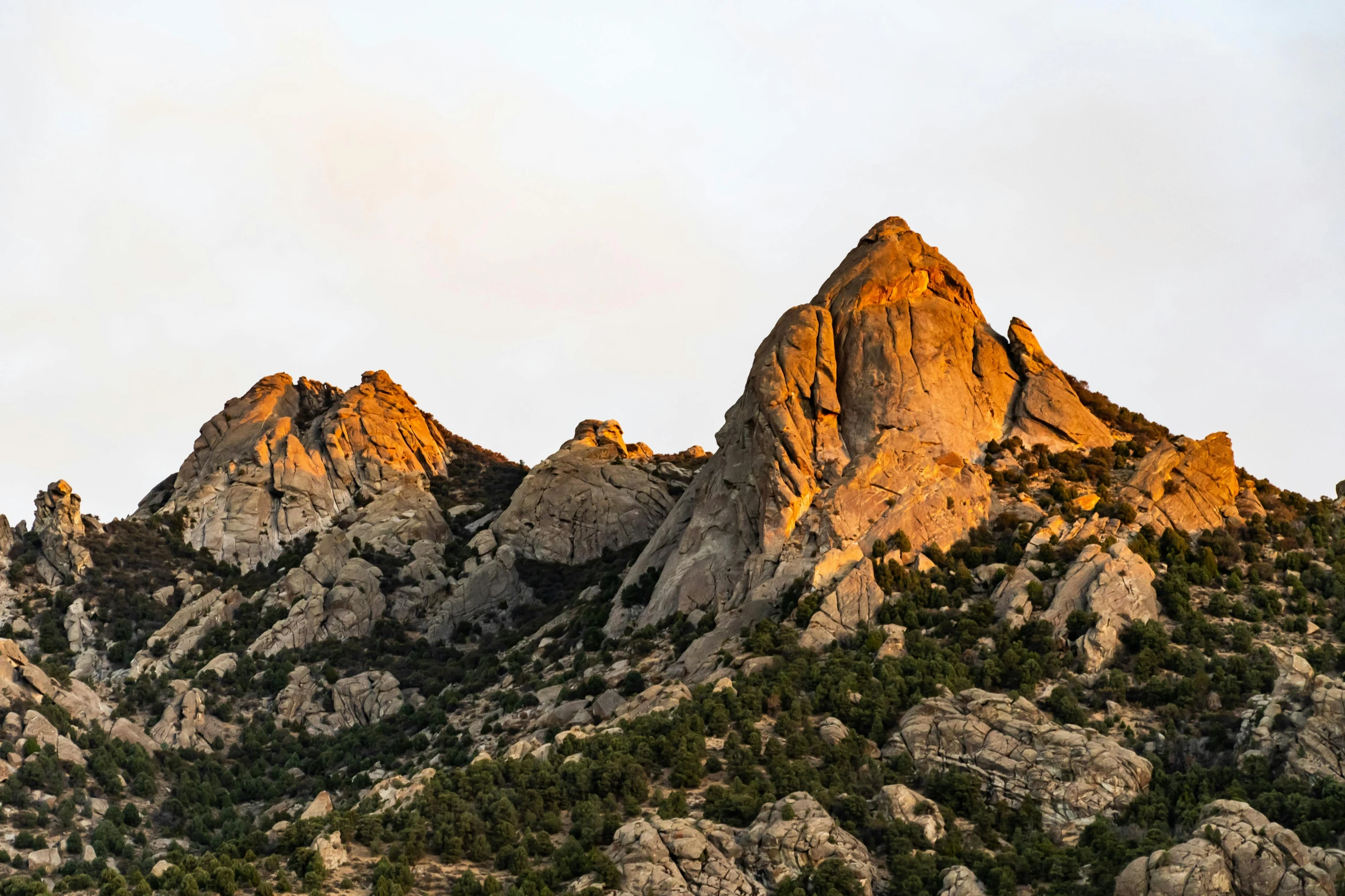 a couple of mountains that are next to each other, unsplash contest winner, dappled in evening light, spikey rocks, brown, panoramic