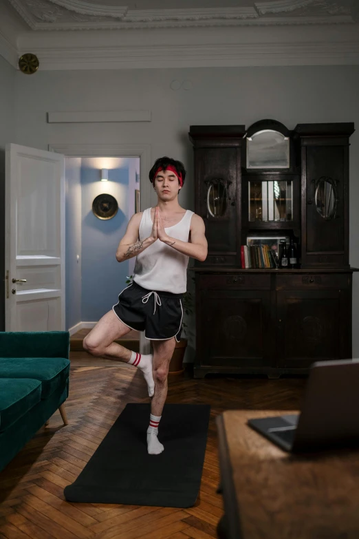 a man standing on a yoga mat in a living room, by Carlo Martini, pexels contest winner, renaissance, cai xukun, in front of a computer, thighs focus, andrzej marszalek