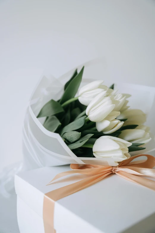 a bouquet of white tulips in a white gift box, by Robbie Trevino, trending on unsplash, delicate details, wrapped, premium, ivy's