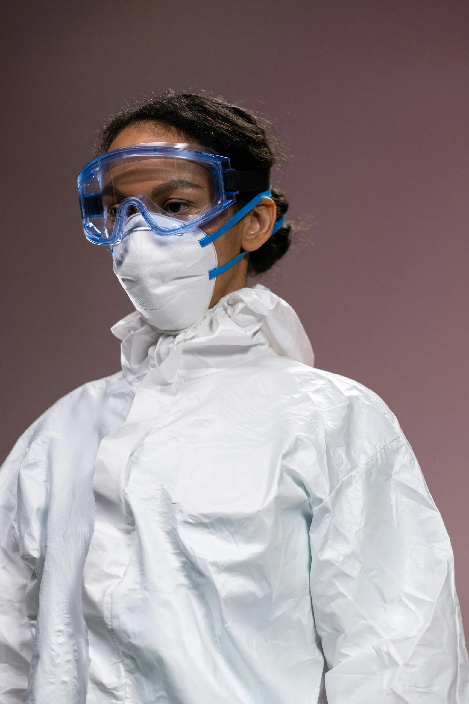 a woman wearing a protective suit and goggles, trending on reddit, plasticien, sterile background, teenager, promo image, up-close