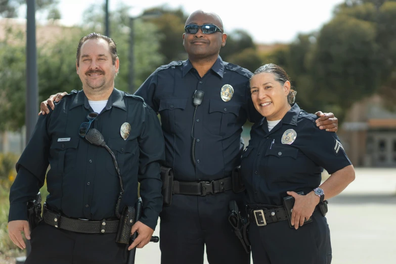 three police officers standing next to each other, a portrait, unsplash, happening, avatar image, los angelos, smiling at camera, getty images proshot