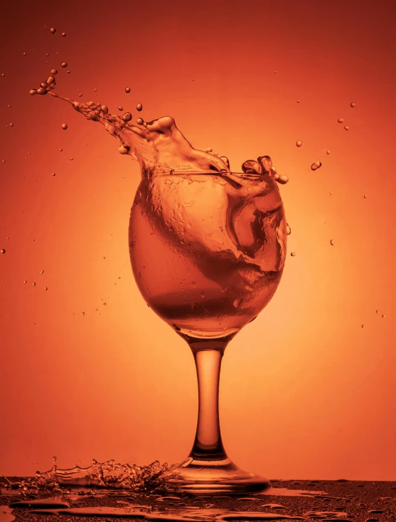 a glass filled with liquid sitting on top of a table, inspired by Mike Winkelmann, shutterstock contest winner, renaissance, orange tint, splashing, sassy pose, promo image