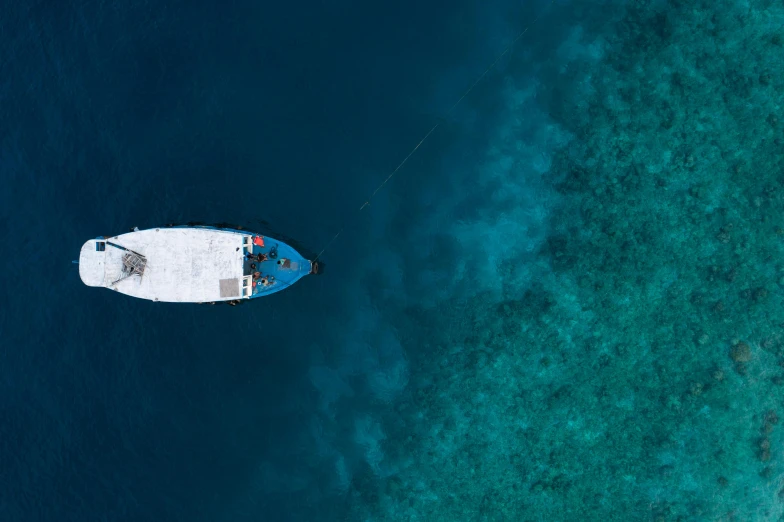 a boat in the middle of a body of water, pexels contest winner, hurufiyya, sapphire waters below, thumbnail, flat lay, full body image