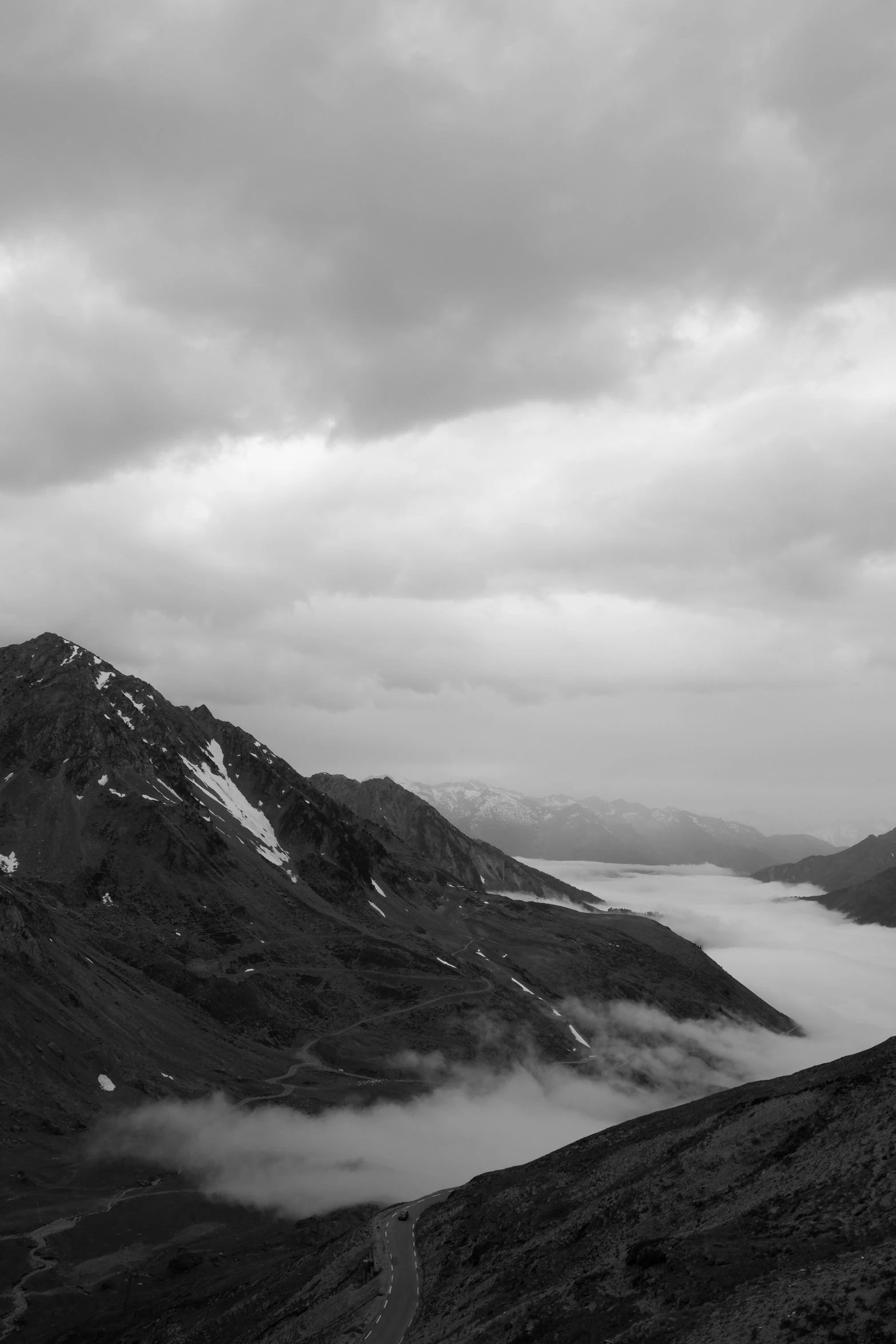 a black and white photo of mountains and clouds, alp, fjord, fog!!!, in white clouds fairyland