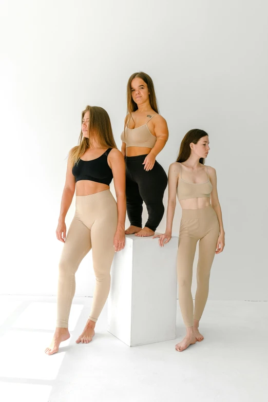 a group of women standing next to each other, inspired by Vanessa Beecroft, renaissance, leggings, light tan, profile image, wearing a crop top