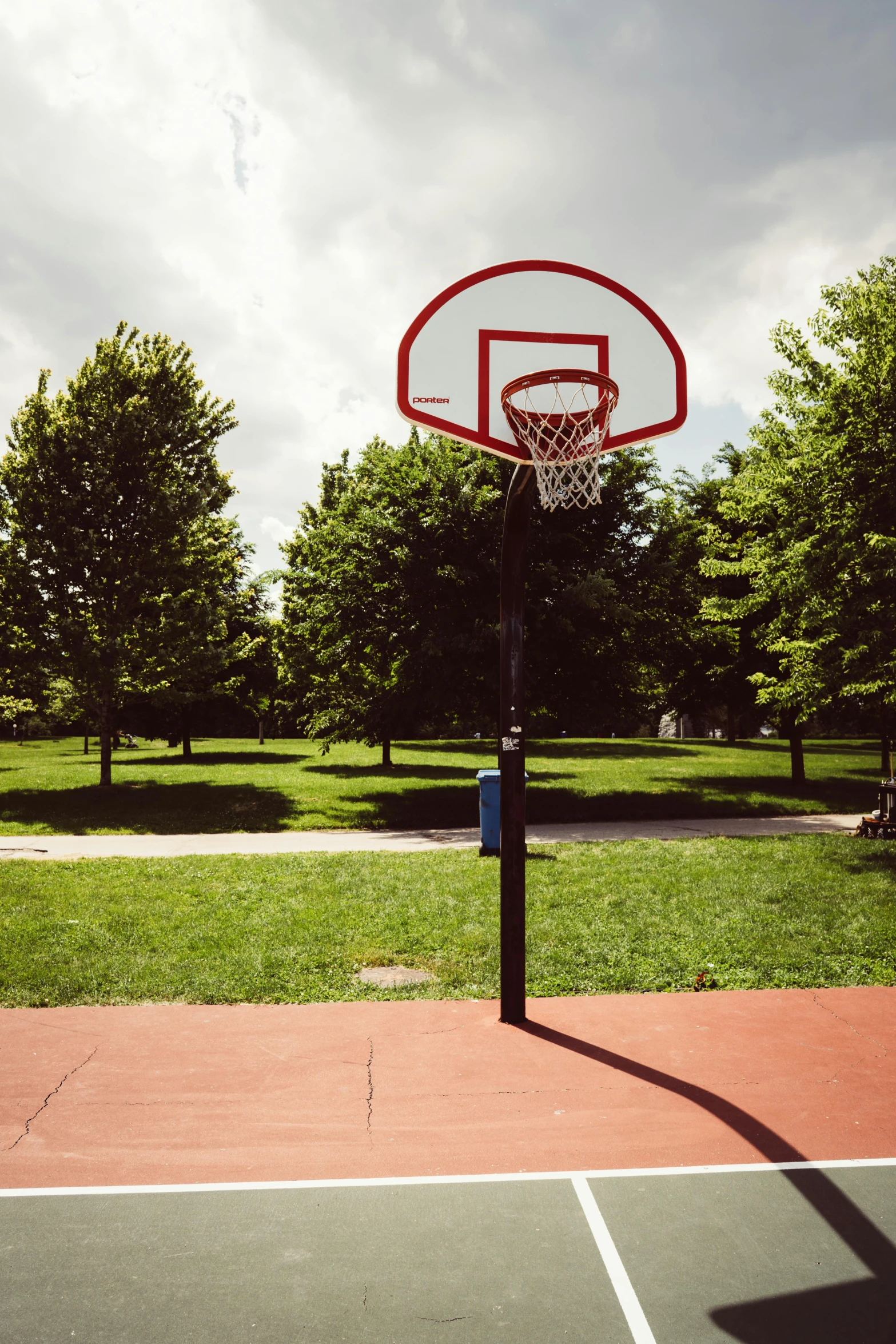 a basketball hoop in a park with trees in the background, by Washington Allston, instagram picture, toronto, cinematic shot ar 9:16 -n 6 -g, feature