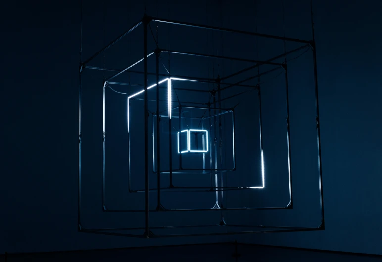 a dark room with a light inside of it, an album cover, inspired by Richard Anuszkiewicz, unsplash, kinetic art, deep blues, square, intricate wires, cube