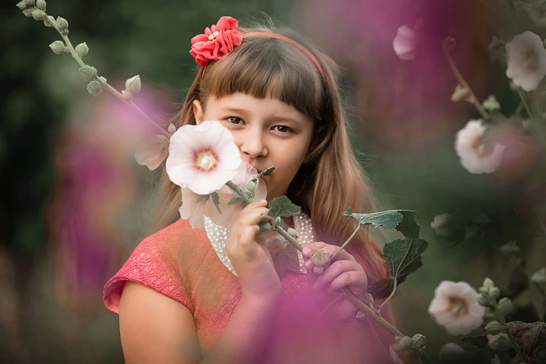 a little girl holding a flower in front of her face, a picture, pixabay contest winner, romanticism, datura, 15081959 21121991 01012000 4k, gorgeous young model, greta thunberg