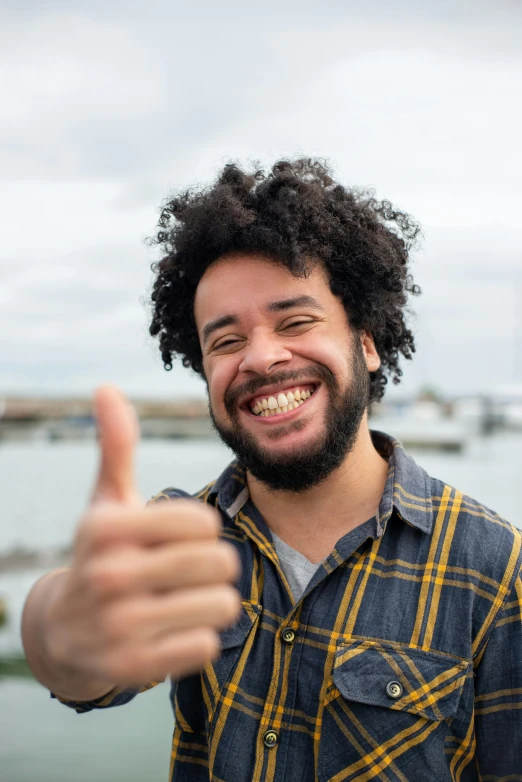 a man with a beard giving a thumbs up, by Washington Allston, pexels contest winner, dark short curly hair smiling, mixed race, subreddit / r / whale, beautiful views