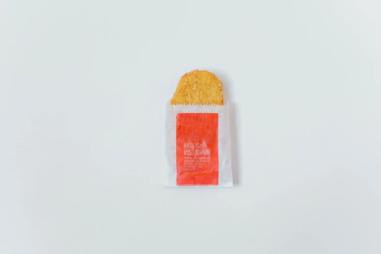 a bag of chips sitting on top of a white surface, an album cover, sōsaku hanga, golden arches, without text, with red haze, recipe