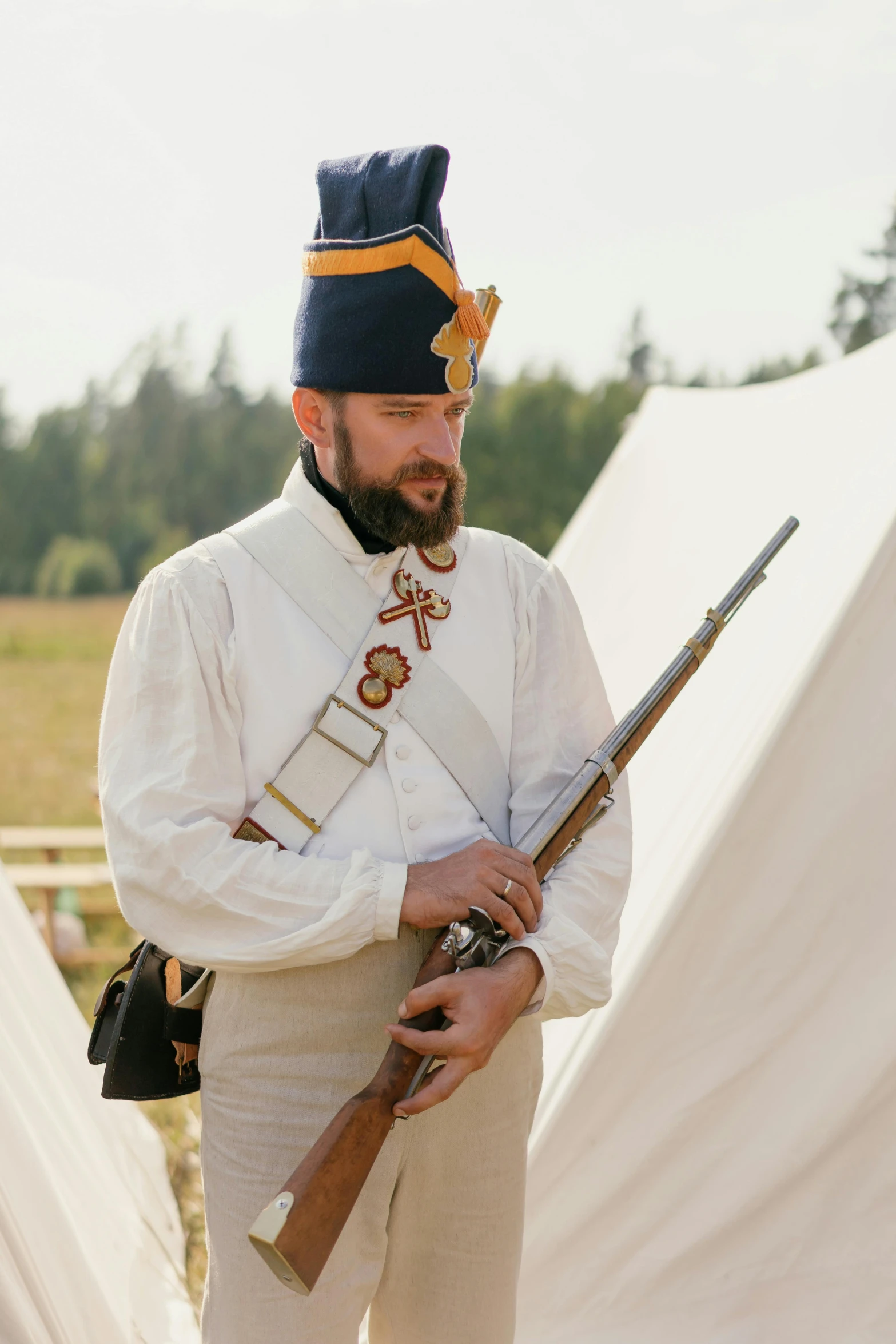 a man in a uniform holding a rifle, inspired by August Friedrich Schenck, unsplash, renaissance, military camp in the background, finland, vendors, 1 8 8 0 s style