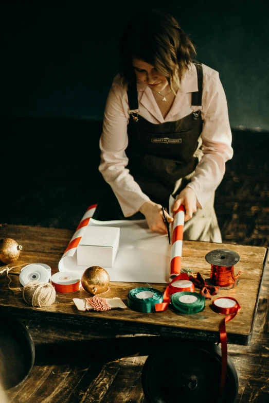 a woman cutting doughnuts on a wooden table, by Matthias Stom, pexels contest winner, process art, candy canes, wide ribbons, inspect in inventory image, square