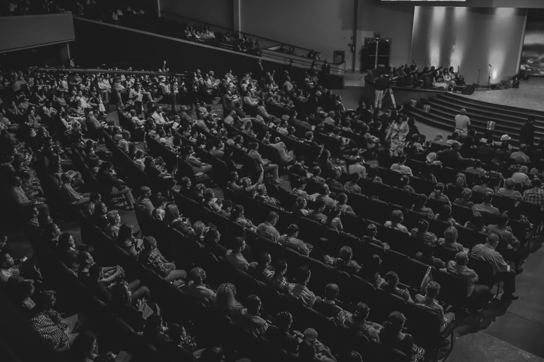 a black and white photo of an auditorium full of people, pexels, churches, carson ellis, instagram post, complex background