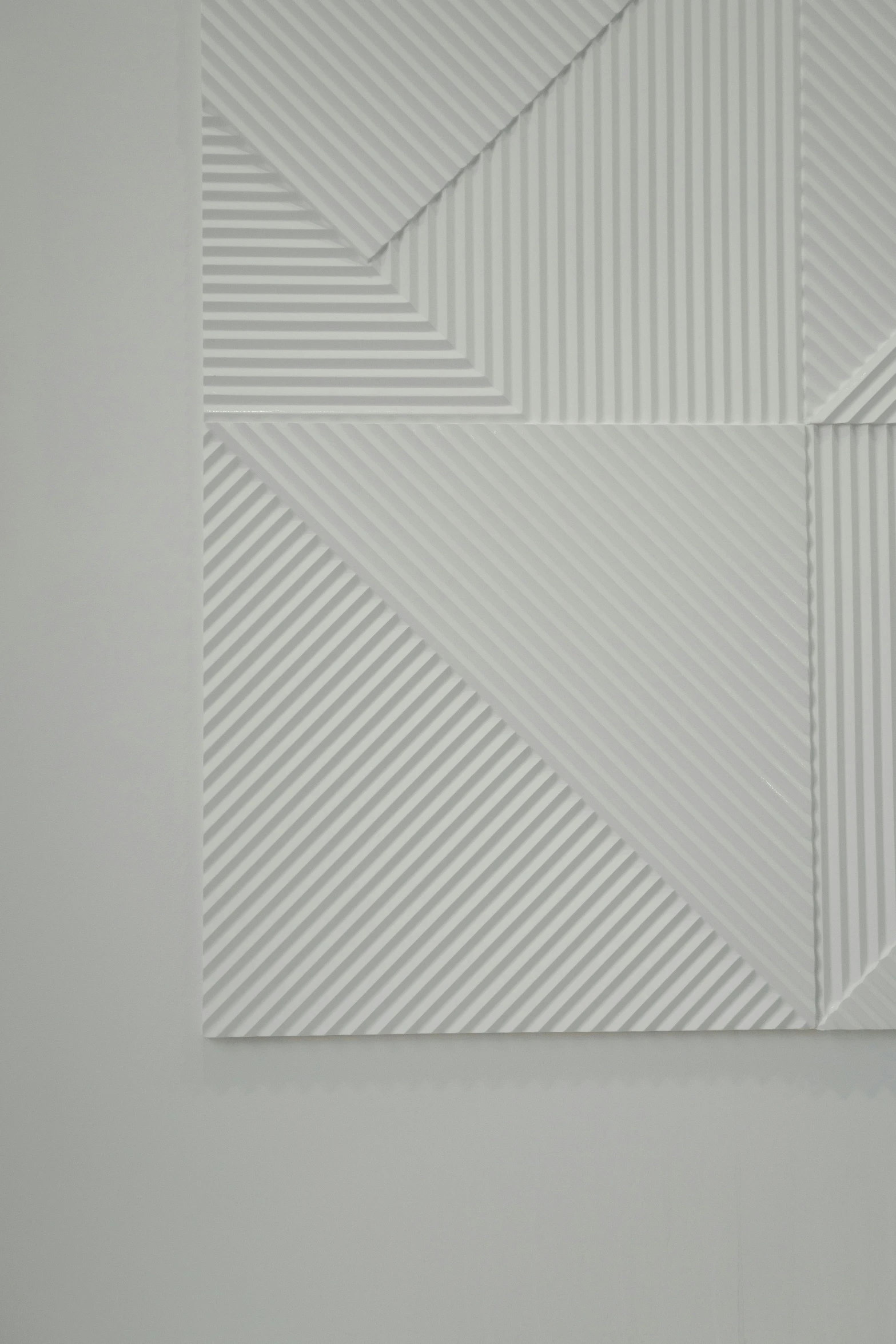 a close up of a piece of art on a wall, by Harvey Quaytman, op art, white carved abstract sculpture, origami studio 3 design, hyung tae kim, ello