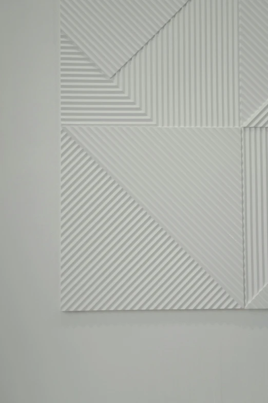 a close up of a piece of art on a wall, by Harvey Quaytman, op art, white carved abstract sculpture, origami studio 3 design, hyung tae kim, ello