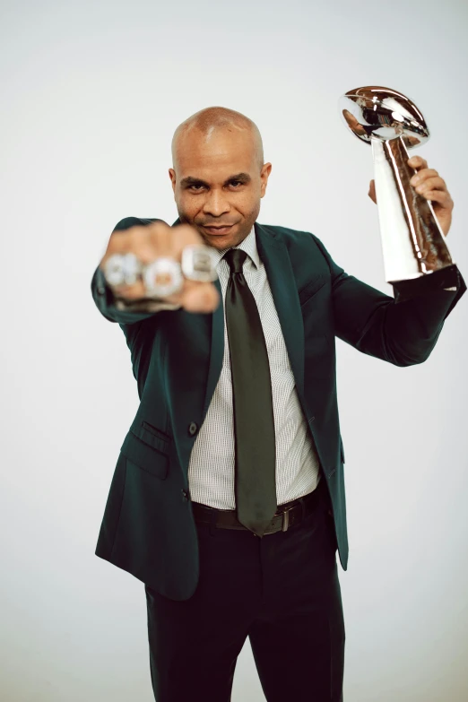 a man in a suit holding a trophy, pointing at the camera, sports illustrated, eric parker, bald on top