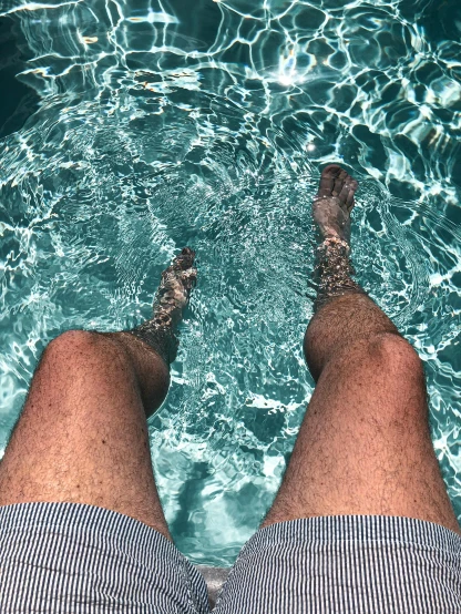 a person standing in a pool with their feet in the water, thighs thighs thighs thighs, reddit post, lachlan bailey, waxy skin