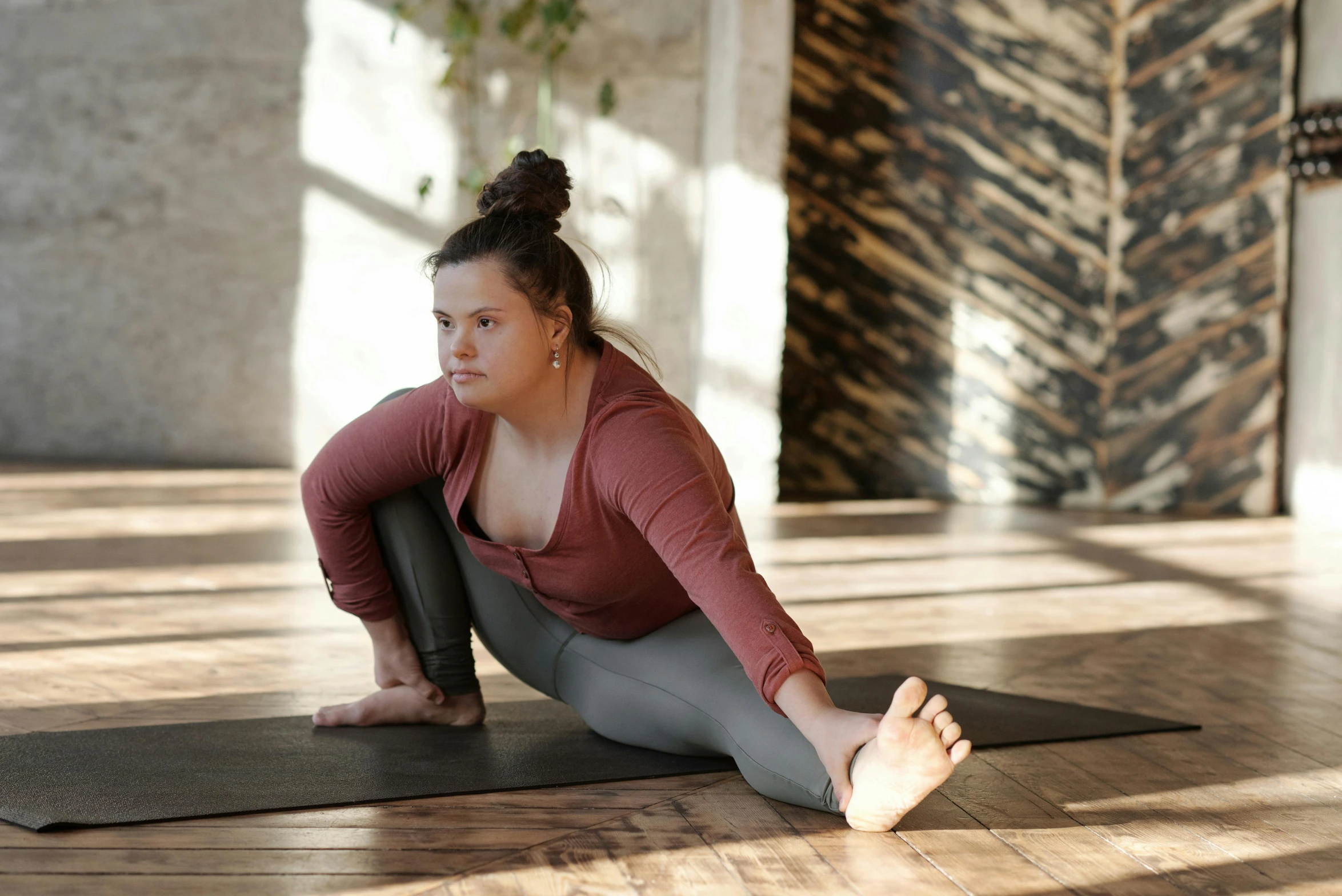 a woman in a yoga pose on a yoga mat, a picture, pexels contest winner, renaissance, overweight, leggings, brown, low quality photo