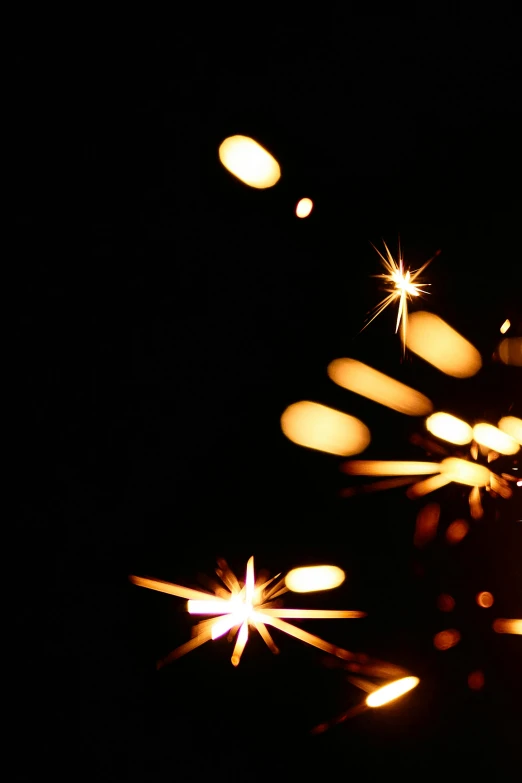 a close up of a sparkler in the dark, an album cover, by Adam Chmielowski, light and space, christmas lights, collapsing stars, ilustration, stockphoto