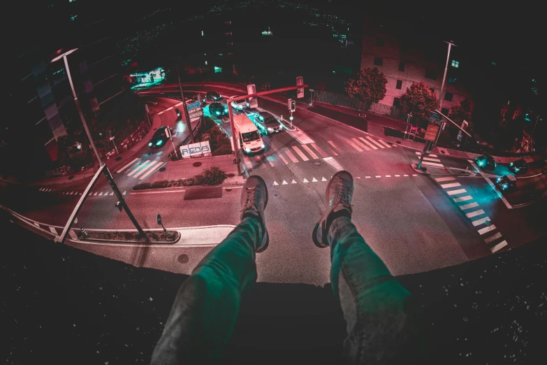 a person standing in the middle of a street at night, by Niko Henrichon, pexels contest winner, sitting in a crane, legs taking your pov, over a cliff, laying down