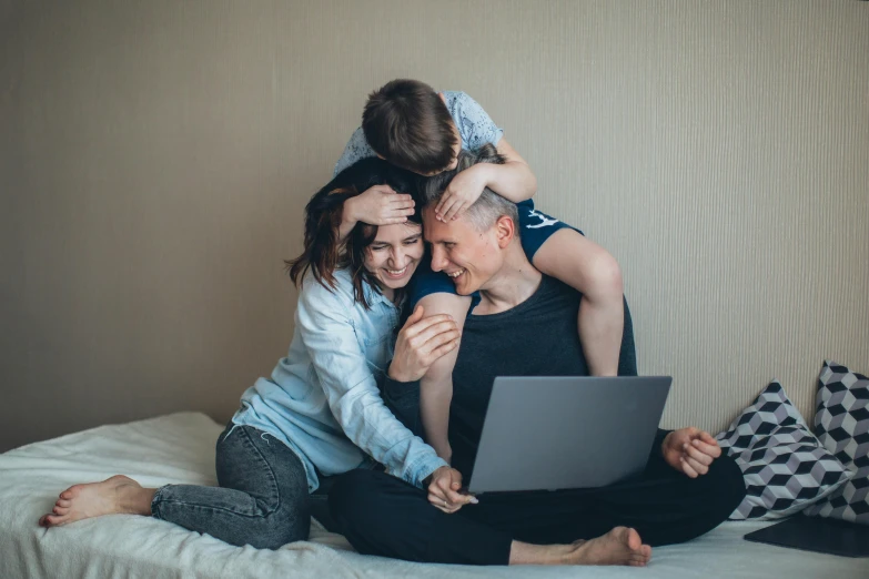 a man and woman sitting on a bed with a laptop, pexels contest winner, portrait of family of three, hugging each other, avatar image, ekaterina