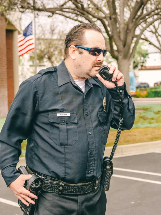 a man in a police uniform talking on a cell phone, with glasses and goatee, 2019 trending photo, **cinematic, nostalgic 8k