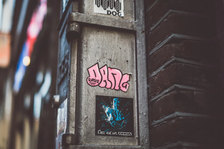 a pole with a bunch of stickers on it, pexels contest winner, graffiti, square sticker, pink, cyberpunk photo, wlop |