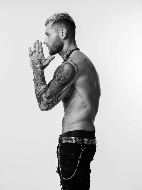 a man with tattoos standing in front of a white background, a photo, inspired by Menez, maxwell boas, view from the side, gal yosef, uploaded