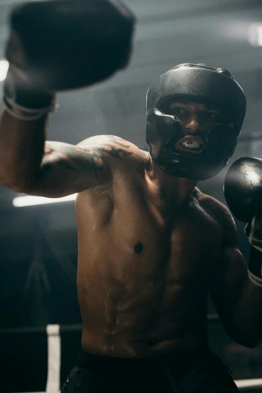 a man wearing boxing gloves in a boxing ring, an album cover, pexels contest winner, happening, helmet on face, 4 k cinematic still, athletic muscle tone, still from a music video